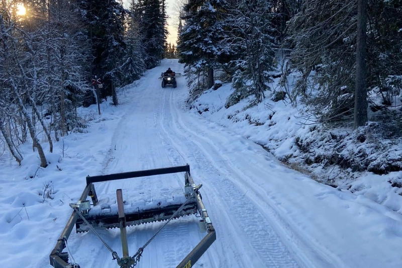 Snötäckt väg i skogen